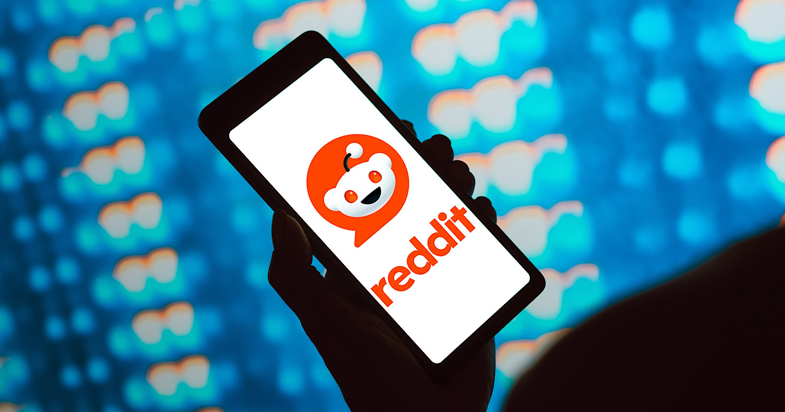 In this photo illustration, the Reddit logo is displayed on a smartphone screen.