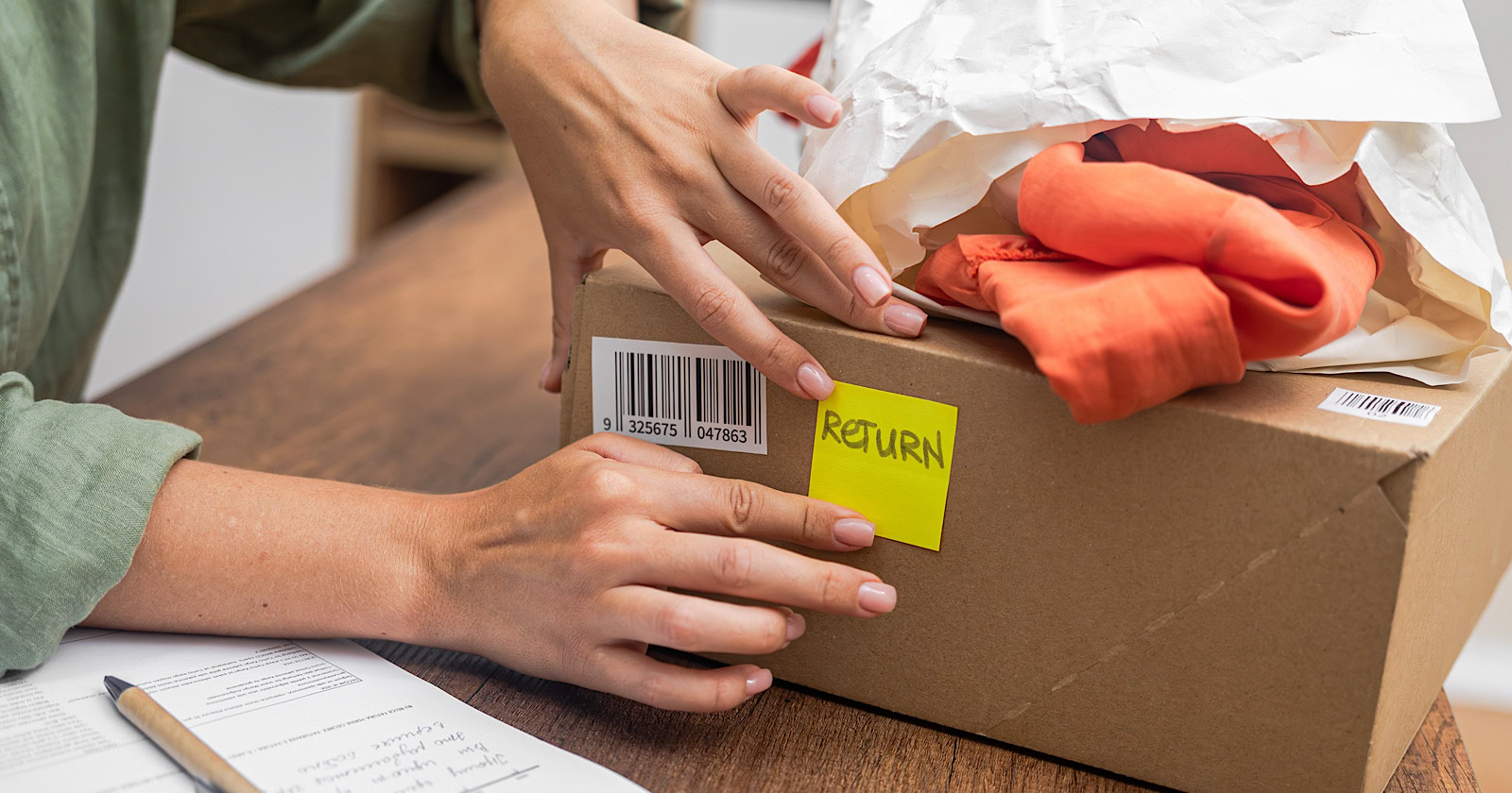 woman online shopper affixes a barcode sticker to a cardboard box, marking it for instrumentality    and refund